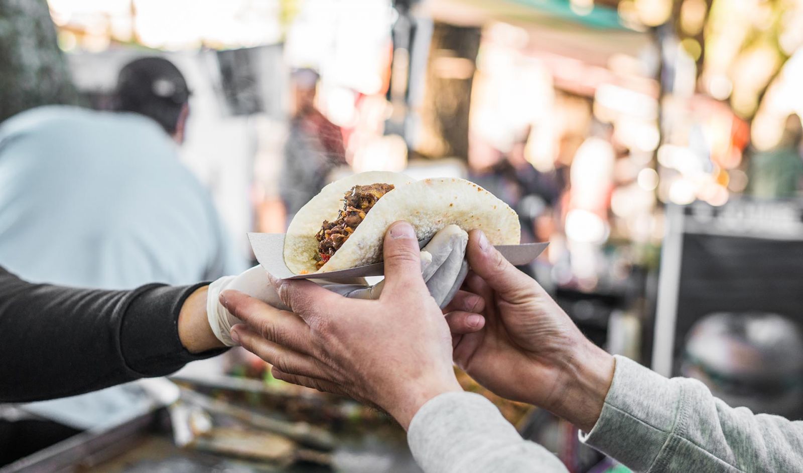 Guy grabbing tacos from a food truck